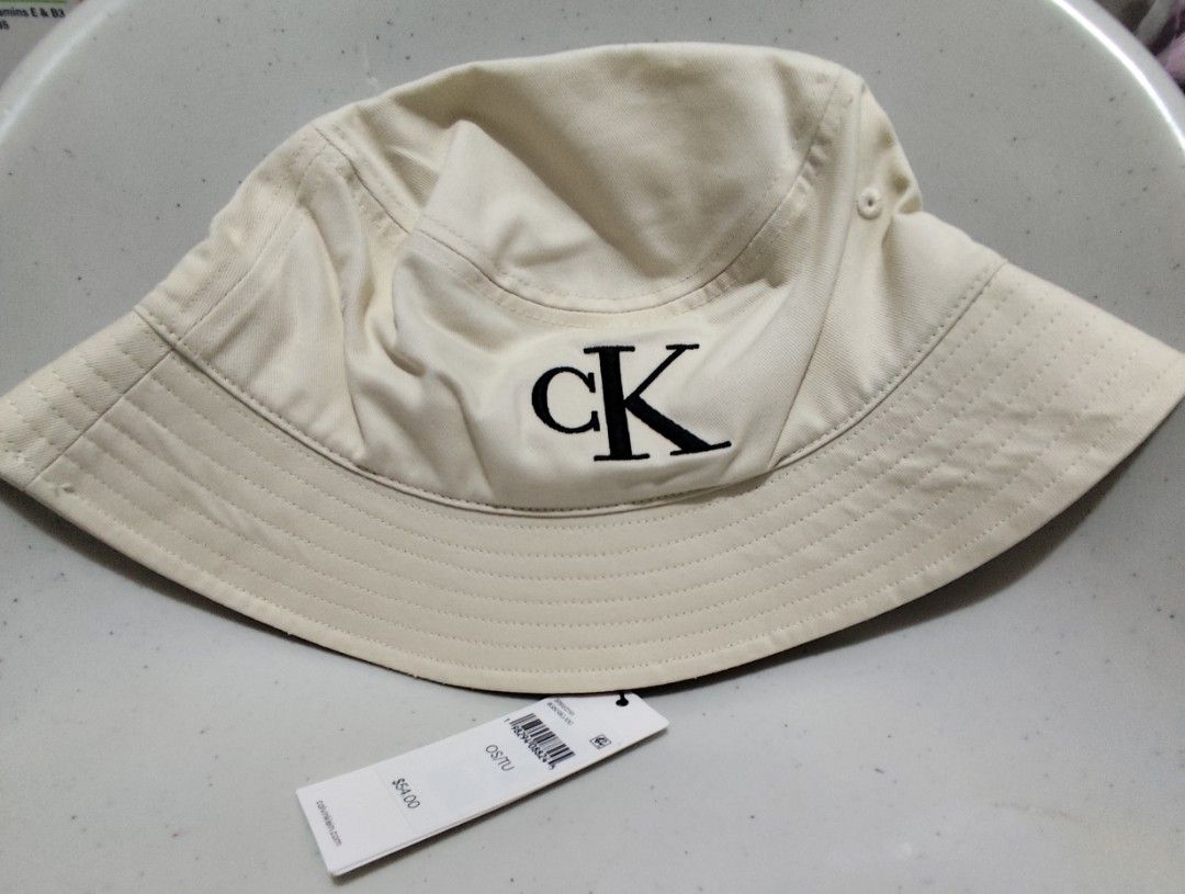 Calvin Klein CK Logo Bucket Hat Cream (Category: Hats & Beanies) located in Imus. Submitted by jmakati22717201 (Listing ID 1463884839, Image 1). Description: - Brand: Calvin Klein - Color: Cream - Style: Bucket Hat - Features: Classic CK logo embroidered on the front - Size: One size fits most - Condition: New with original tag attached - Perfect for: Sunny days.