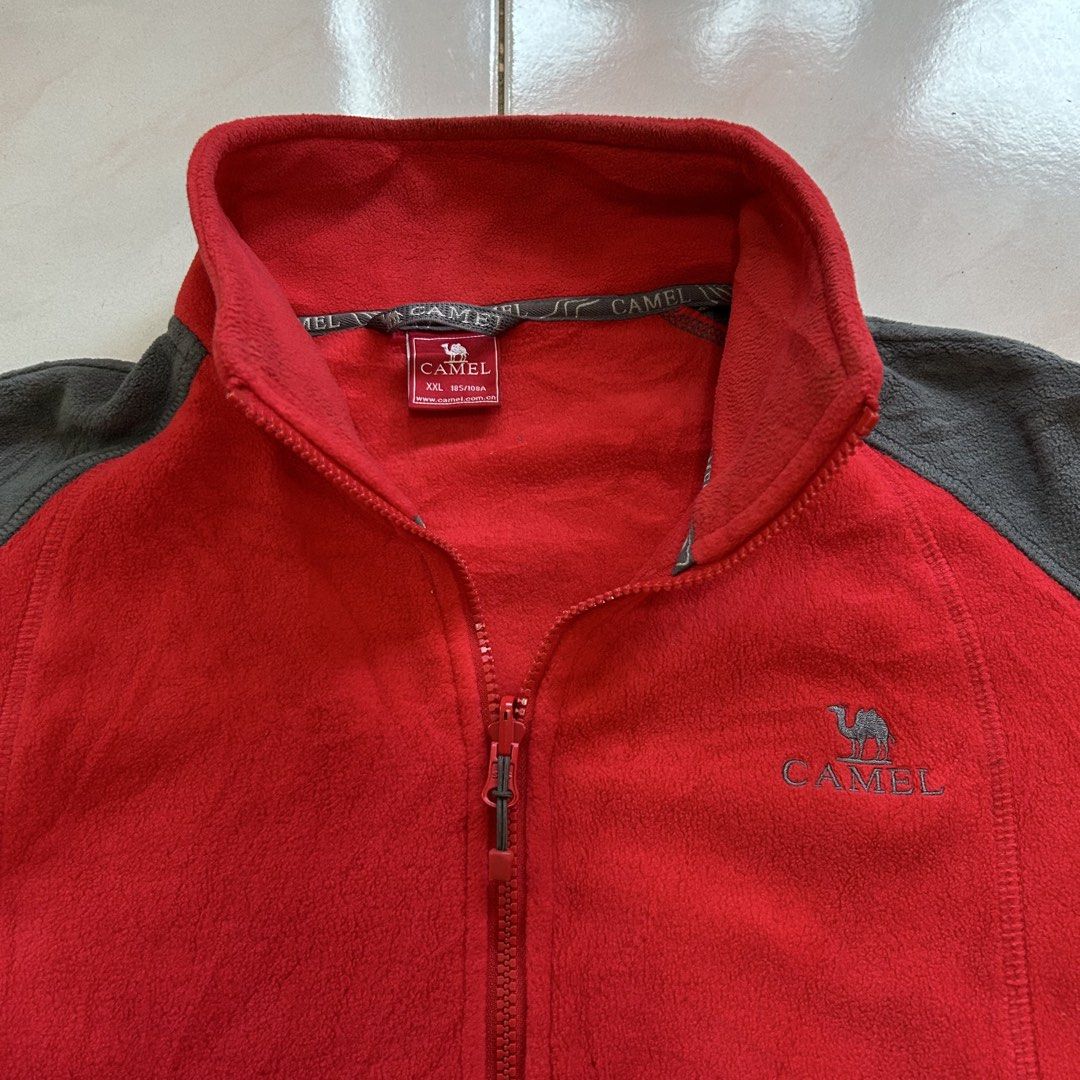 Camel Fleece Jacket Red Grey 🔥 (Category: Coats, Jackets and Outerwear) located in Jinoba-an. Submitted by eegiboy (Listing ID 1463776087, Image 2). Description: - Red and grey Camel fleece jacket - Size XXL - Full zip front - Two zip pockets - Warm and comfortable fleece material - Ideal for layering, standalone wear, outdoor activities, or casual outings Wts: Camel sherpa jacket 🔥 Size: Xl-xxl Dimes: 24/29 Excellent condition 🥰 Needwash 😉 6