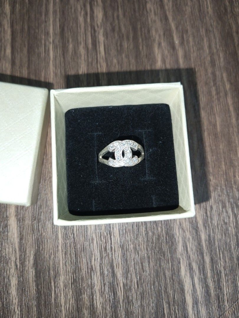CC Logo Ring with Crystals (Category: Rings) located in Naga. Submitted by esteemed_shop (Listing ID 1463784728, Image 1). Description: - Elegant silver-tone ring - Features iconic CC logo design - Embellished with sparkling small crystals - Approximately size 7 (as per ring sizer) - Includes a beautiful gift box - Ideal for daily wear or special events.