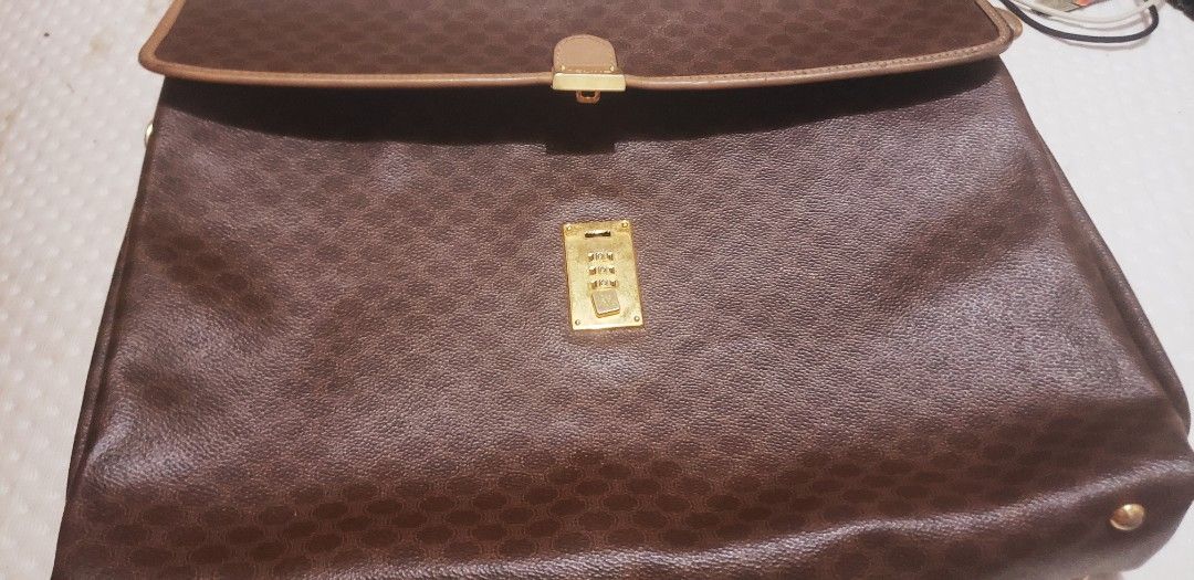 Celine Monogram Canvas Leather Trim Handbag (Category: Luxury Bags & Wallets) located in Marikina City. Submitted by racoon143 (Listing ID 1463855871, Image 1). Description: - Classic Celine monogram handbag - Color: Brown canvas with tan leather trim and handle - Hardware: Gold-tone - Closure: Combination lock - Style: Timeless piece for everyday use.