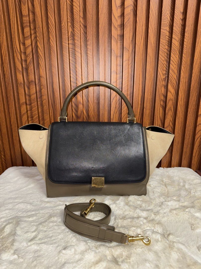 Authentic Celine Trapeze Black Leather Suede (Category: Luxury Bags & Wallets) located in Subic. Submitted by luxshoppe88 (Listing ID 1463804036, Image 1). Description: - Authentic Celine bag - Material: Black leather and beige suede - Features: Top handle and detachable shoulder strap - Hardware: Gold details - Closure: Zipper on back pocket and interior zipper with Celine branding - Versatile: Ideal for everyday or special occasions - Still in 