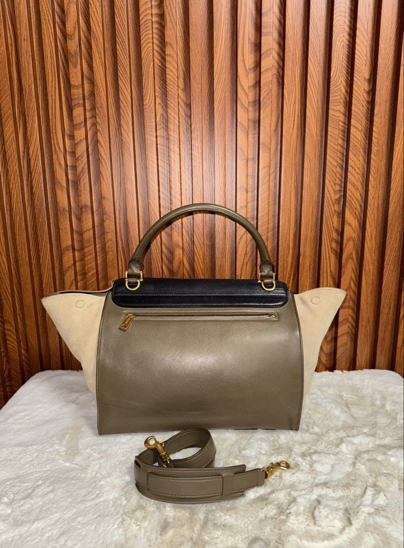 Authentic Celine Trapeze Black Leather Suede (Category: Luxury Bags & Wallets) located in Subic. Submitted by luxshoppe88 (Listing ID 1463804036, Image 3). Description: - Authentic Celine bag - Material: Black leather and beige suede - Features: Top handle and detachable shoulder strap - Hardware: Gold details - Closure: Zipper on back pocket and interior zipper with Celine branding - Versatile: Ideal for everyday or special occasions - Still in 