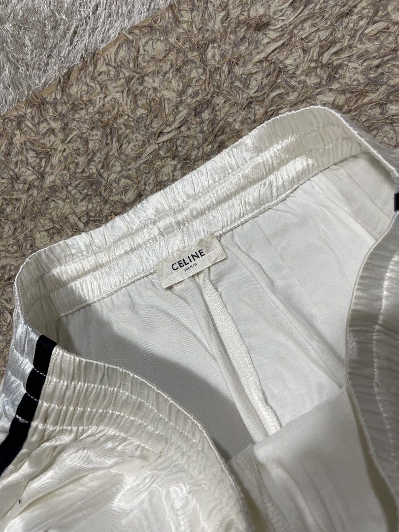 Celine White Satin Shorts with Black Trim (Category: Luxury Apparel) located in Manila. Submitted by rutchemari68583 (Listing ID 1463843653, Image 3). Description: - Brand: Celine - Color: White - Material: Satin (very shiny) - Features: Elastic waistband with drawstring, black trim along sides and hem - Style: Ideal for lounging or casual wear Waistline 28-30.