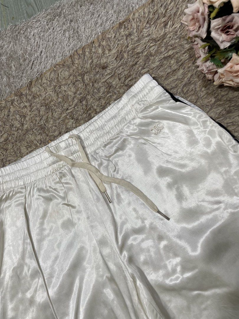 Celine White Satin Shorts with Black Trim (Category: Luxury Apparel) located in Manila. Submitted by rutchemari68583 (Listing ID 1463843653, Image 2). Description: - Brand: Celine - Color: White - Material: Satin (very shiny) - Features: Elastic waistband with drawstring, black trim along sides and hem - Style: Ideal for lounging or casual wear Waistline 28-30.