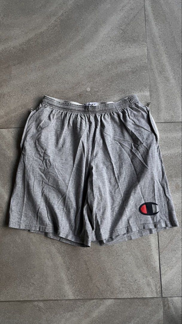 Champion Grey Athletic Shorts Size M (Category: Shorts) located in Cabuyao City. Submitted by bulandos (Listing ID 1463862461, Image 2). Description: - Grey Champion Shorts - Size: Medium - Elastic waistband with drawstring - Classic Champion logo on left leg - Comfortable cotton-polyester blend - Ideal for lounging and workouts.