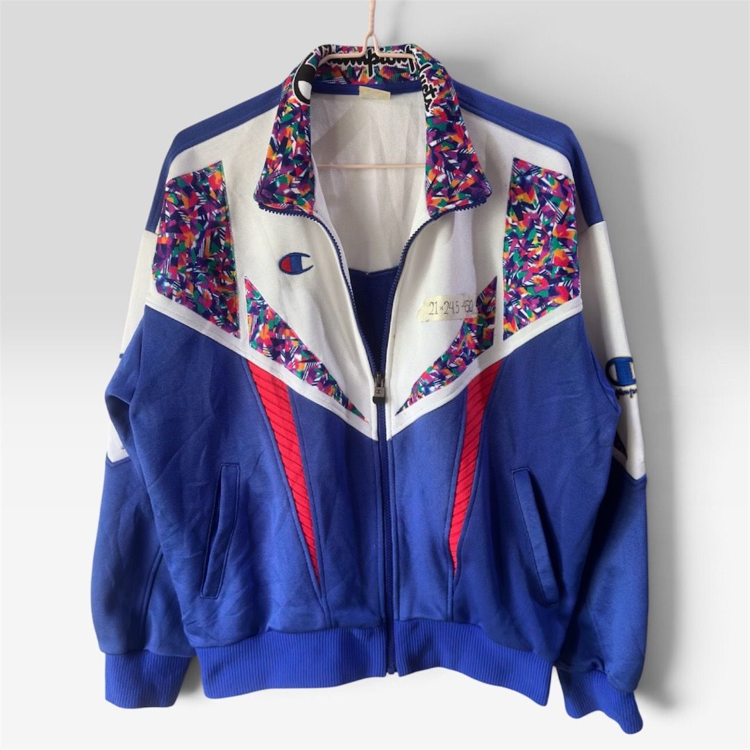 Champion Track Jacket (Category: Coats, Jackets and Outerwear) located in Cagayan de Oro. Submitted by caspian_thrift (Listing ID 1463761674, Image 1). Description: - Vintage Champion track jacket - Bold blue, white, and red color block design - Colorful abstract pattern on collar and shoulders - Full zip front closure - Convenient pockets - Perfect for casual wear or sports activities.