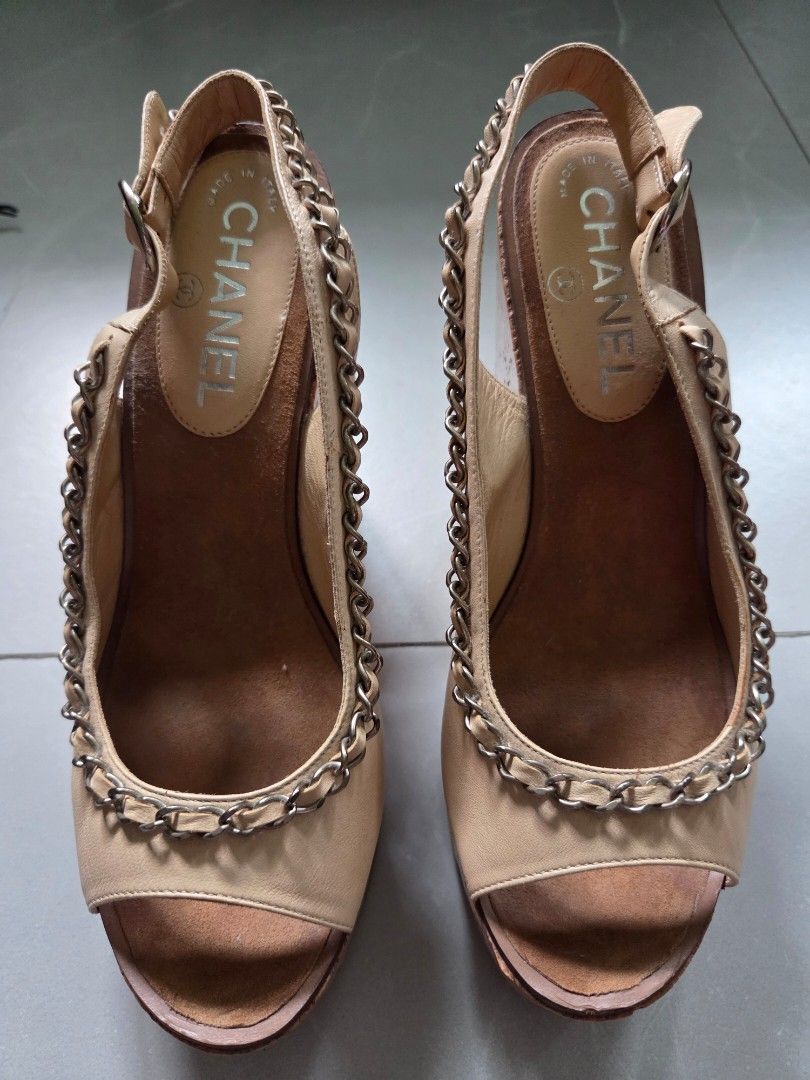 Chanel Beige Leather Chain Wedge Sandals (Category: Flats & Sandals) located in Paranaque City. Submitted by thepennydreadful (Listing ID 1463817733, Image 2). Description: Size 37/37.5 Guaranteed Authentic 💯 - Authentic Chanel wedge sandals in a versatile beige leather. - Comfortable cork wedge with signature CC logo detail. - Secure and stylish slingback strap with adjustable buckle closure. - Elegant chain accent around the sandal opening. - 