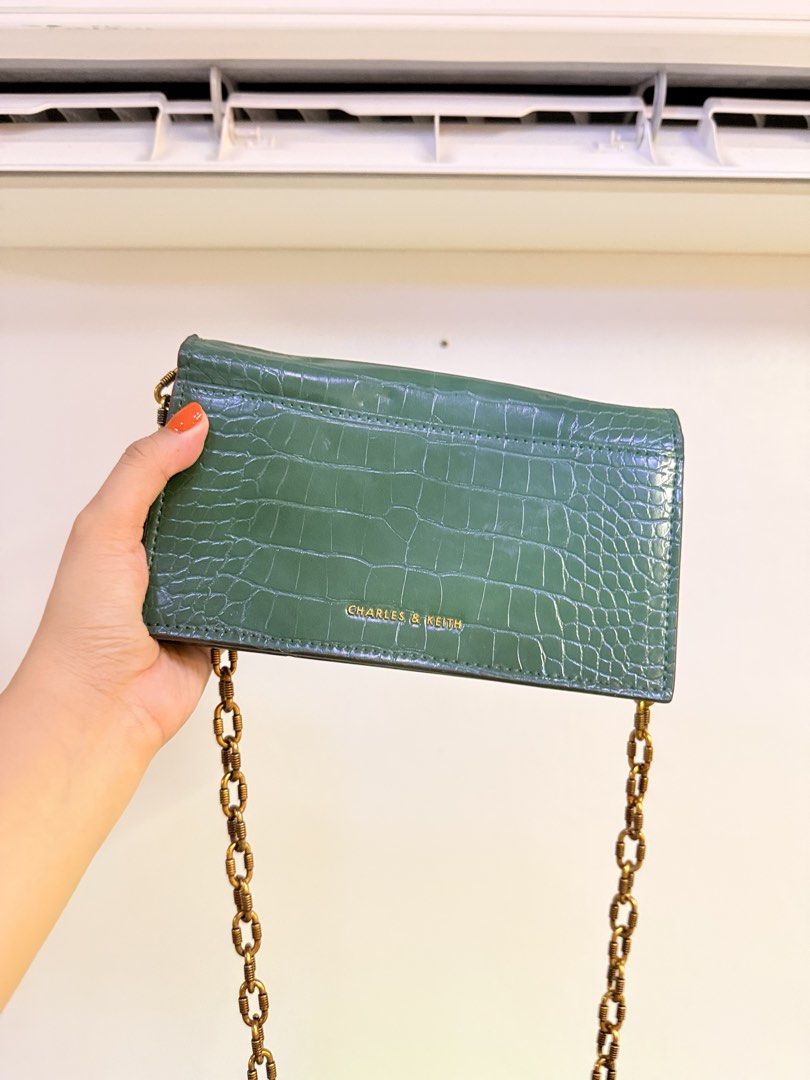 Charles & Keith Green Croc Embossed Chain Shoulder Bag (Category: Shoulder Bags) located in Pasig City. Submitted by yoursunshinelover (Listing ID 1463843745, Image 2). Description: Some issue: some sides have peeling but not noticeable, i wouldn’t notice it if i didn’t check before selling - Stylish green shoulder bag - Luxurious croc-embossed texture - Elegant gold chain strap - Unique marble-like clasp closure - Multiple interior card slots - 