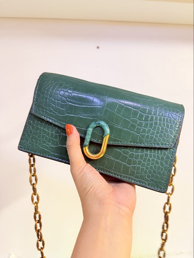 Charles & Keith Green Croc Embossed Chain Shoulder Bag (Category: Shoulder Bags) located in Pasig City. Submitted by yoursunshinelover (Listing ID 1463843745, Image 1). Description: Some issue: some sides have peeling but not noticeable, i wouldn’t notice it if i didn’t check before selling - Stylish green shoulder bag - Luxurious croc-embossed texture - Elegant gold chain strap - Unique marble-like clasp closure - Multiple interior card slots - 