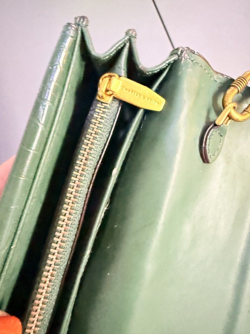 Charles & Keith Green Croc Embossed Chain Shoulder Bag (Category: Shoulder Bags) located in Pasig City. Submitted by yoursunshinelover (Listing ID 1463843745, Image 3). Description: Some issue: some sides have peeling but not noticeable, i wouldn’t notice it if i didn’t check before selling - Stylish green shoulder bag - Luxurious croc-embossed texture - Elegant gold chain strap - Unique marble-like clasp closure - Multiple interior card slots - 