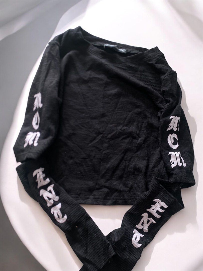 Chrome Hearts Black Ribbed Long Sleeve Top (Category: Longsleeves) located in General Trias. Submitted by mangu_ukay (Listing ID 1463748939, Image 2). Description: - Brand: Chrome Hearts - Style: Black ribbed long sleeve top - Design: White gothic text graphic on sleeves - Material: 100% Cotton - Origin: Made in USA (RN#95024) - Versatile: Great for layering or wearing solo.