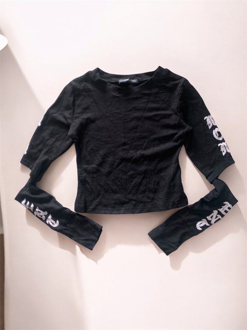 Chrome Hearts Black Ribbed Long Sleeve Top (Category: Longsleeves) located in General Trias. Submitted by mangu_ukay (Listing ID 1463748939, Image 1). Description: - Brand: Chrome Hearts - Style: Black ribbed long sleeve top - Design: White gothic text graphic on sleeves - Material: 100% Cotton - Origin: Made in USA (RN#95024) - Versatile: Great for layering or wearing solo.
