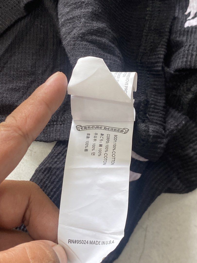 Chrome Hearts Black Ribbed Long Sleeve Top (Category: Longsleeves) located in General Trias. Submitted by mangu_ukay (Listing ID 1463748939, Image 3). Description: - Brand: Chrome Hearts - Style: Black ribbed long sleeve top - Design: White gothic text graphic on sleeves - Material: 100% Cotton - Origin: Made in USA (RN#95024) - Versatile: Great for layering or wearing solo.
