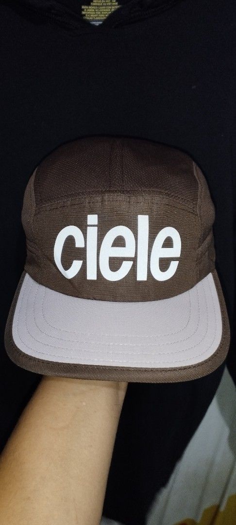 Ciele Athletics Brown 5 Panel Cap (Category: Caps & Hats) located in Manila. Submitted by beckster_nnline_luxuryshop (Listing ID 1463851468, Image 1). Description: - Brand: Ciele Athletics - Style: 5-panel cap - Features: White 'ciele' logo on front, adjustable strap at back - Ideal for: Running, casual wear - Condition: Good.
