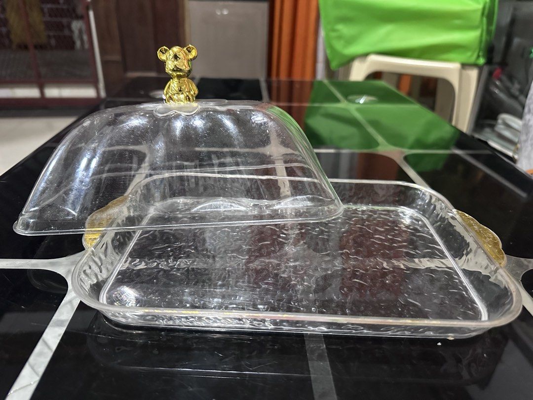 Clear Serving Tray with Bear Handle Dome Lid (Category: Food Organization & Storage) located in Manila. Submitted by zuripot0726 (Listing ID 1463870618, Image 2). Description: - Serving tray with a clear dome lid - Adorable gold bear handle on the lid - Convenient gold handles on the sides of the tray - Ideal for serving cakes, pastries, and other food items - Helps keep food fresh and protected - Great for parties and everyday use - dimensions o