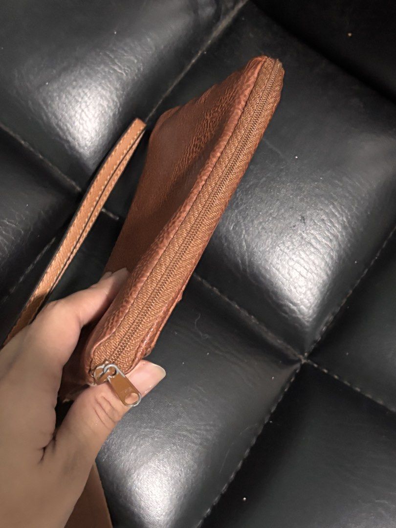 Coach Brown Leather Wristlet Pouch with Tag (Category: Luxury Bags & Wallets) located in La Trinidad. Submitted by caicai1926 (Listing ID 1463769403, Image 2). Description: - Authentic Coach brown leather wristlet - Secure zippered closure - Detachable wrist strap for versatility - Includes original Coach leather tag - Spacious interior for your essentials - Ideal for quick errands and outings.