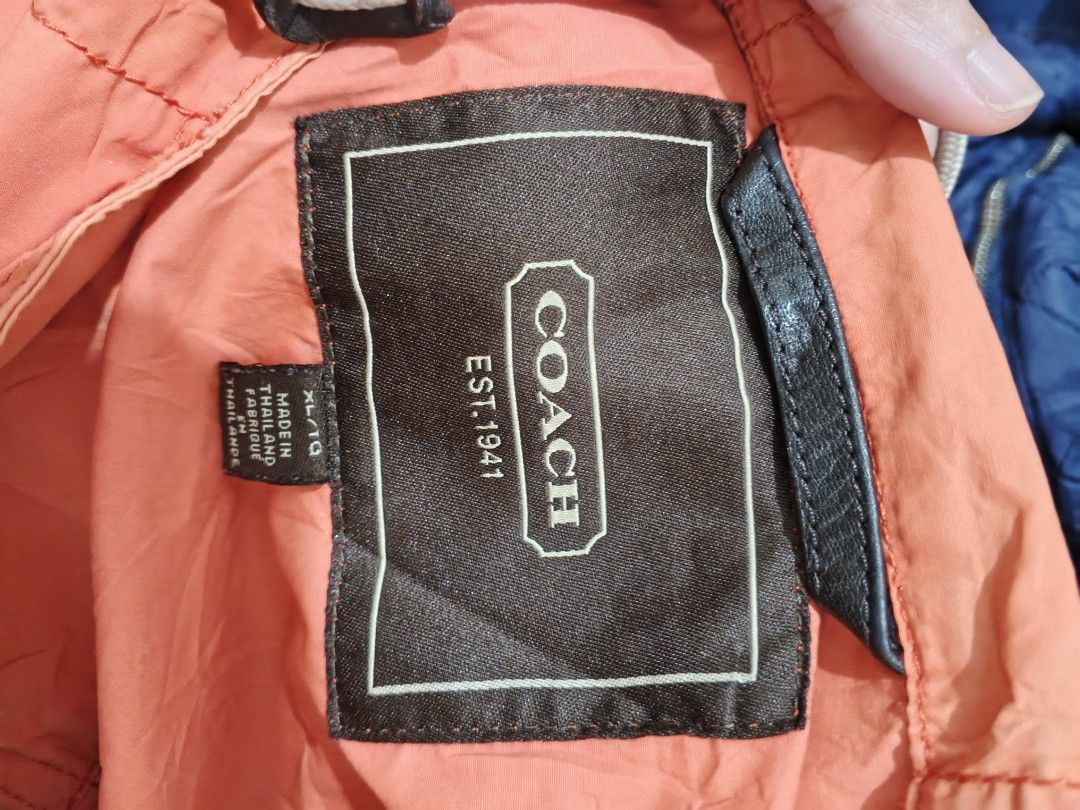 COACH HOODED JACKET (Category: Coats, Jackets and Outerwear) located in Bulacan. Submitted by annenicathriftthriftlang (Listing ID 1463850761, Image 2). Description: COACH EST. 1941 HOODED JACKET - XL ON TAG Dimes: 25 x 28 on tape (XL) Width: 25 inches pit to pit Length: 28 inches Sleeve: 27 inches Size: XL on tag, fits L to XL Tela: Nylon / Cotton blend - windbreaker, manipis pero quality Color rate: 7/10 - Condition: Excellent - buo lahat zippe