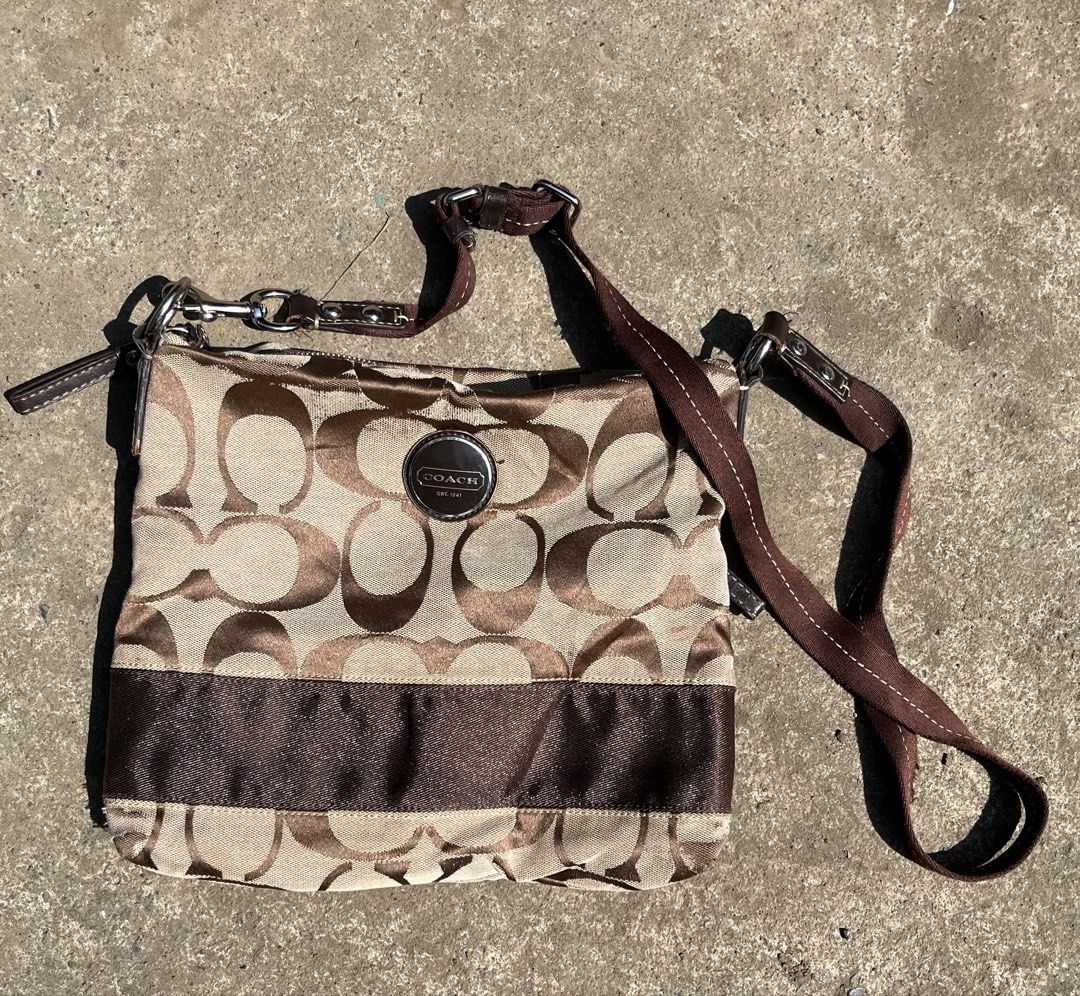 Coach Monogram Canvas Crossbody Bag Brown (Category: Luxury Bags & Wallets) located in Butuan. Submitted by flipnragsph (Listing ID 1463749593, Image 1). Description: - Authentic Coach crossbody bag - Classic brown and beige monogram pattern - Stylish brown ribbon detail on the front - Interior zippered pocket for secure storage - Proudly made in the Philippines - Ideal for everyday wear and tear.