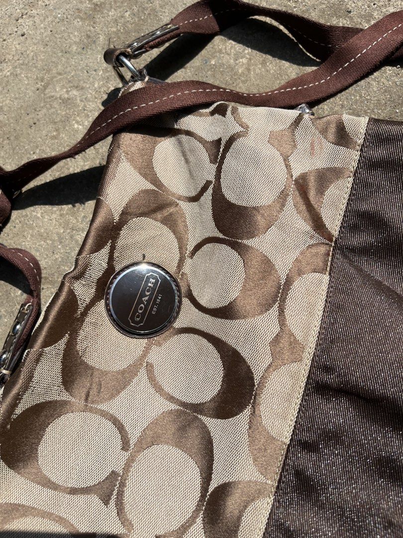 Coach Monogram Canvas Crossbody Bag Brown (Category: Luxury Bags & Wallets) located in Butuan. Submitted by flipnragsph (Listing ID 1463749593, Image 2). Description: - Authentic Coach crossbody bag - Classic brown and beige monogram pattern - Stylish brown ribbon detail on the front - Interior zippered pocket for secure storage - Proudly made in the Philippines - Ideal for everyday wear and tear.