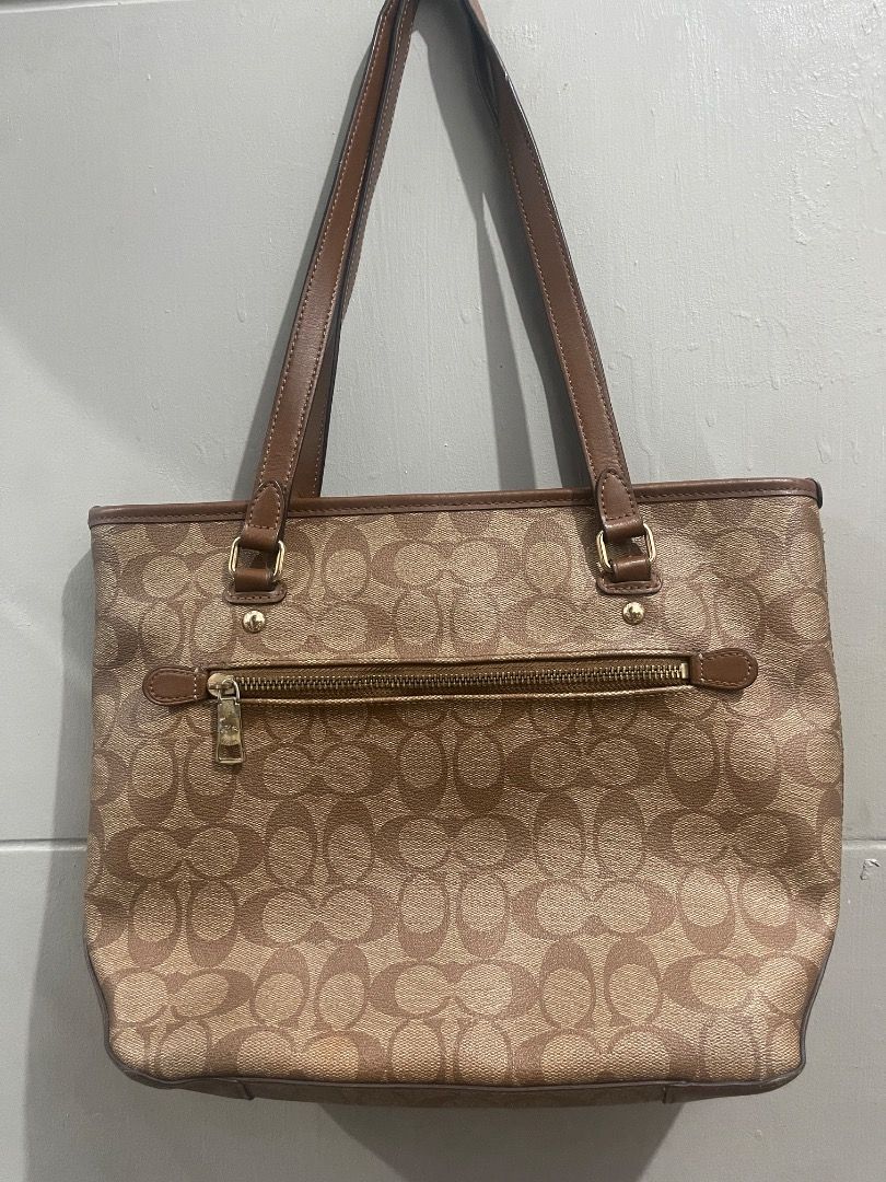 Coach Monogram Canvas Leather Trim Tote Bag (Category: Luxury Bags & Wallets) located in Marikina City. Submitted by bezz_bezzy (Listing ID 1463751550, Image 2). Description: - Classic Coach tote bag - Brown monogram canvas with leather trim - Interior zip pocket and slip pockets - Zippers in good working condition - Minor signs of wear on interior leather tag.