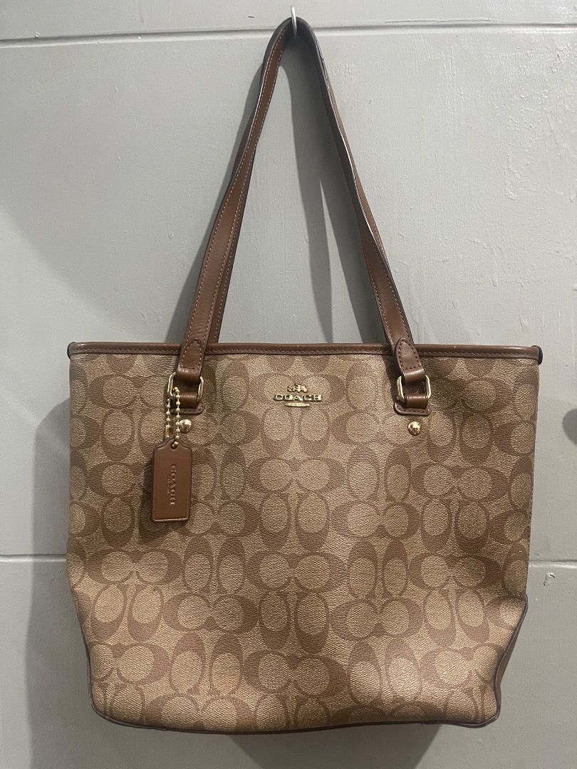 Coach Monogram Canvas Leather Trim Tote Bag (Category: Luxury Bags & Wallets) located in Marikina City. Submitted by bezz_bezzy (Listing ID 1463751550, Image 1). Description: - Classic Coach tote bag - Brown monogram canvas with leather trim - Interior zip pocket and slip pockets - Zippers in good working condition - Minor signs of wear on interior leather tag.