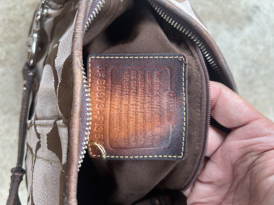 Coach Monogram Canvas Shoulder Bag (Category: Luxury Bags & Wallets) located in M'Lang. Submitted by alexpabillo0324 (Listing ID 1463757317, Image 3). Description: - Classic Coach monogram shoulder bag - Color: Brown and tan signature 'C' pattern - Material: Leather trim and strap - Closure: Zipper - Interior: Includes leather tag with serial number - Condition: Some wear on leather strap and trim - Perfect for everyday use.