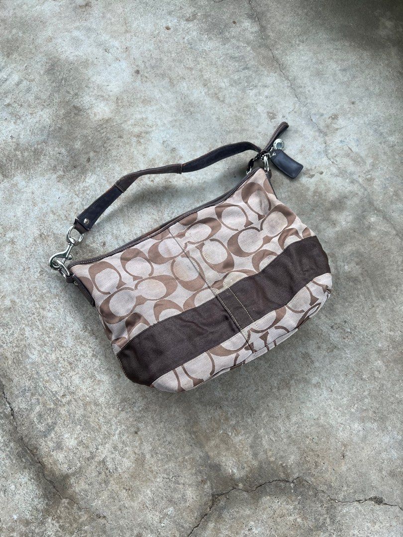 Coach Monogram Canvas Shoulder Bag (Category: Luxury Bags & Wallets) located in M'Lang. Submitted by alexpabillo0324 (Listing ID 1463757317, Image 2). Description: - Classic Coach monogram shoulder bag - Color: Brown and tan signature 'C' pattern - Material: Leather trim and strap - Closure: Zipper - Interior: Includes leather tag with serial number - Condition: Some wear on leather strap and trim - Perfect for everyday use.