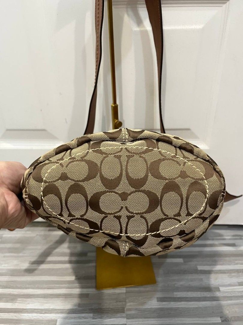 Coach Monogram Leather Bucket Bag (Category: Luxury Bags & Wallets) located in Quezon City. Submitted by chicberry (Listing ID 1463766724, Image 3). Description: - Classic Coach bucket bag - Signature monogram canvas with brown leather trim - Adjustable shoulder strap - Gold hardware details - Spacious interior for essentials - Timeless piece for everyday use.