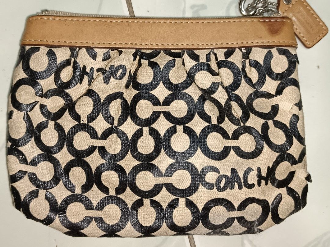 Coach Monogram Wristlet Pouch (Category: Purses & Pouches) located in Manila. Submitted by caaths_collection (Listing ID 1463844900, Image 3). Description: PLS check all picture - Coach monogram wristlet pouch - Classic tan and black pattern with leather trim - Secure zipper closure - Interior lined in blue - Shows some signs of wear on exterior fabric and leather - Ideal for carrying your daily essentials - AS IS.