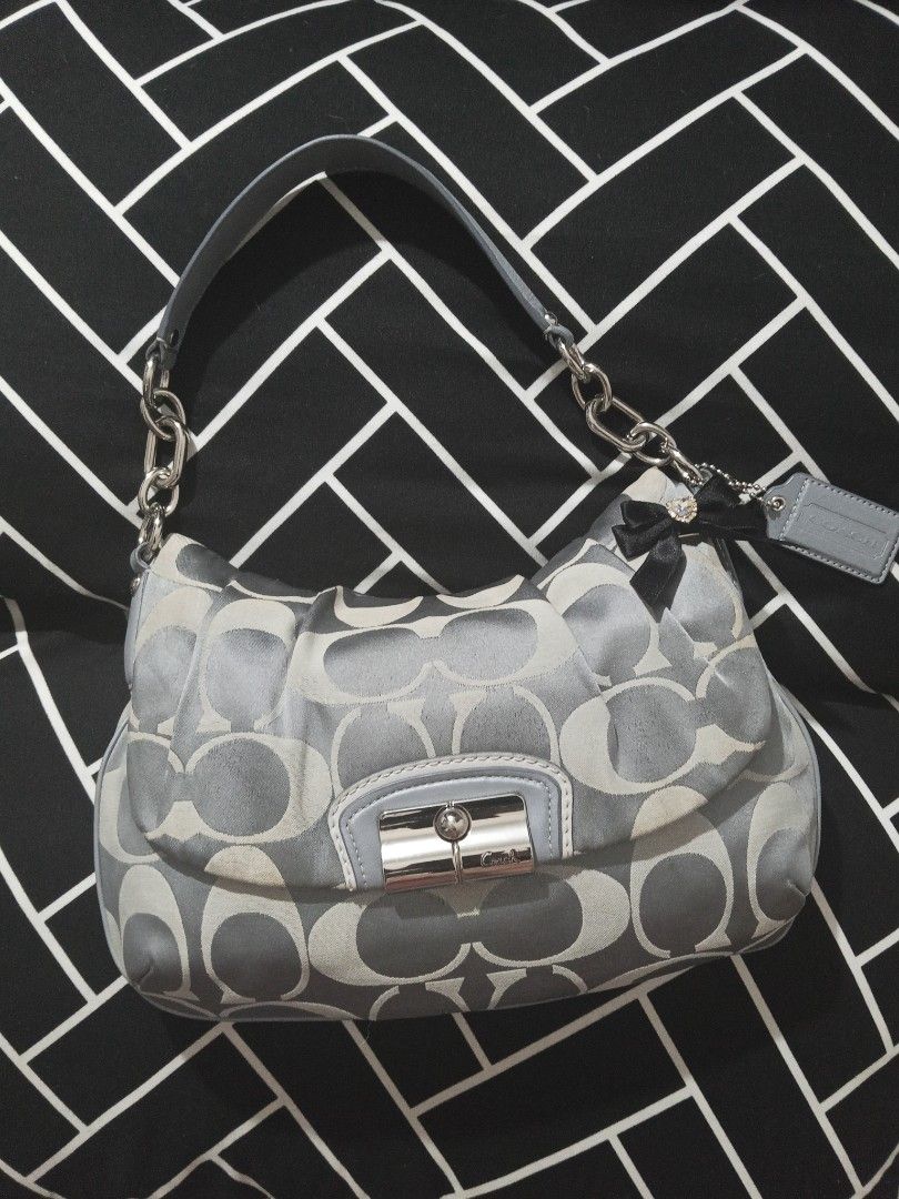Coach Op Art Signature Bag (Category: Shoulder Bags) located in Makati City. Submitted by makati_metro (Listing ID 1463907384, Image 1). Description: ✨ In good vintage condition! - Smells clean - Has a pretty, Soho-inspired look. - Leather and buckles are in excellent condition. - Canvas has NO holes or tears, just minor signs of use and a few storage stains. - Could use a little cleaning to freshen it up, but the bag still looks very pretty and 
