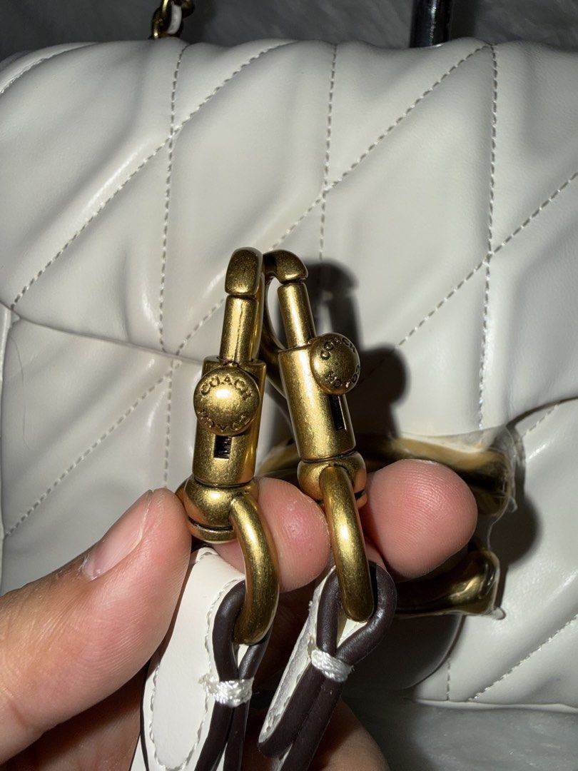 Coach Pillow Tabby Shoulder Bag 18 White (Category: Shoulder Bags) located in Taguig. Submitted by roseanneramirez (Listing ID 1463830807, Image 2). Description: - White quilted leather Coach Pillow Tabby 18 bag - Gold hardware with iconic C logo closure - Comes with both a chain strap and a leather shoulder strap - Versatile wear: shoulder bag or crossbody - Ideal for everyday use.