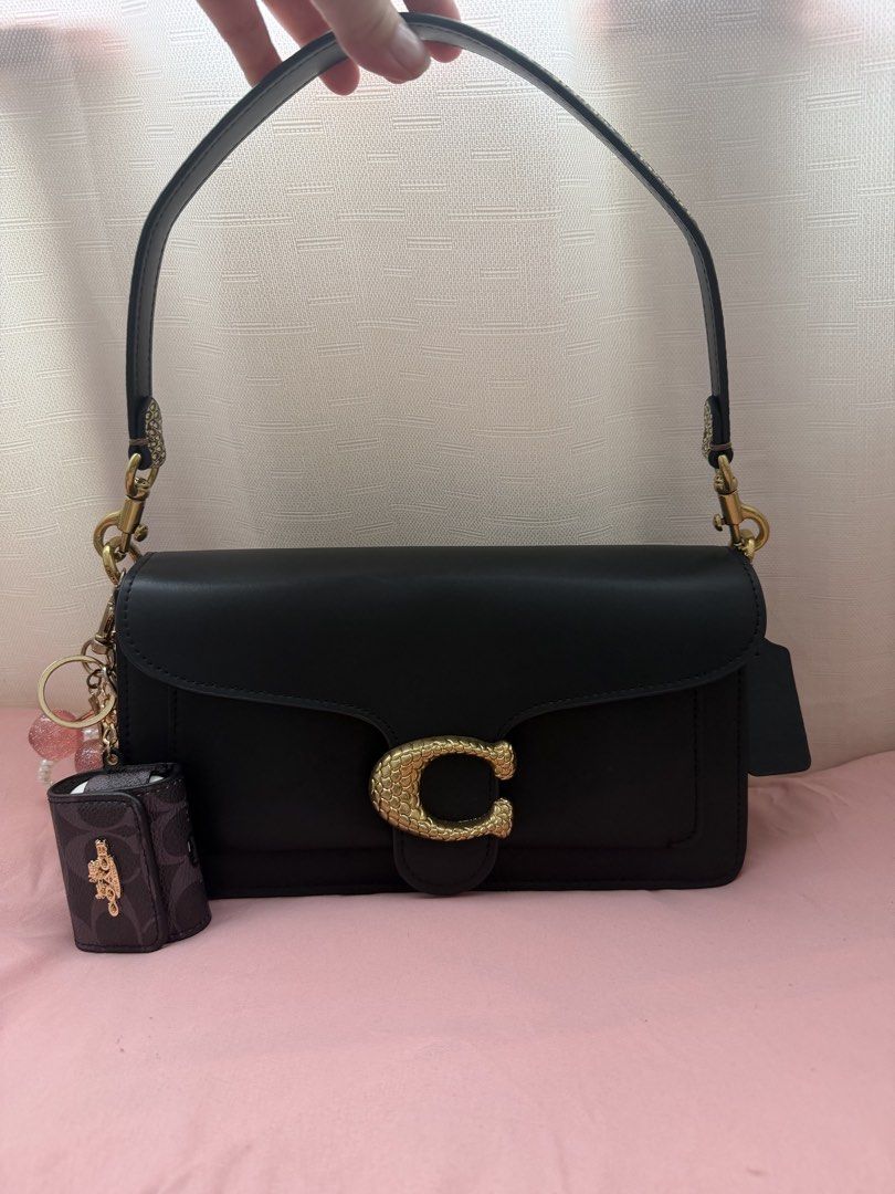 Coach tabby (snake edition) (Category: Luxury Bags & Wallets) located in Manila. Submitted by theabolivar (Listing ID 1463773264, Image 3). Description: - Brand: Coach - Model: Tabby (Snake Edition) - Type: Shoulder Bag - Color: Black - Design: Features a unique snake-embossed strap and gold-tone hardware. - Condition: brandnew - Style: Luxurious and eye-catching. With paper bag and dust bag Free card holder from mango 📍 las pinas.
