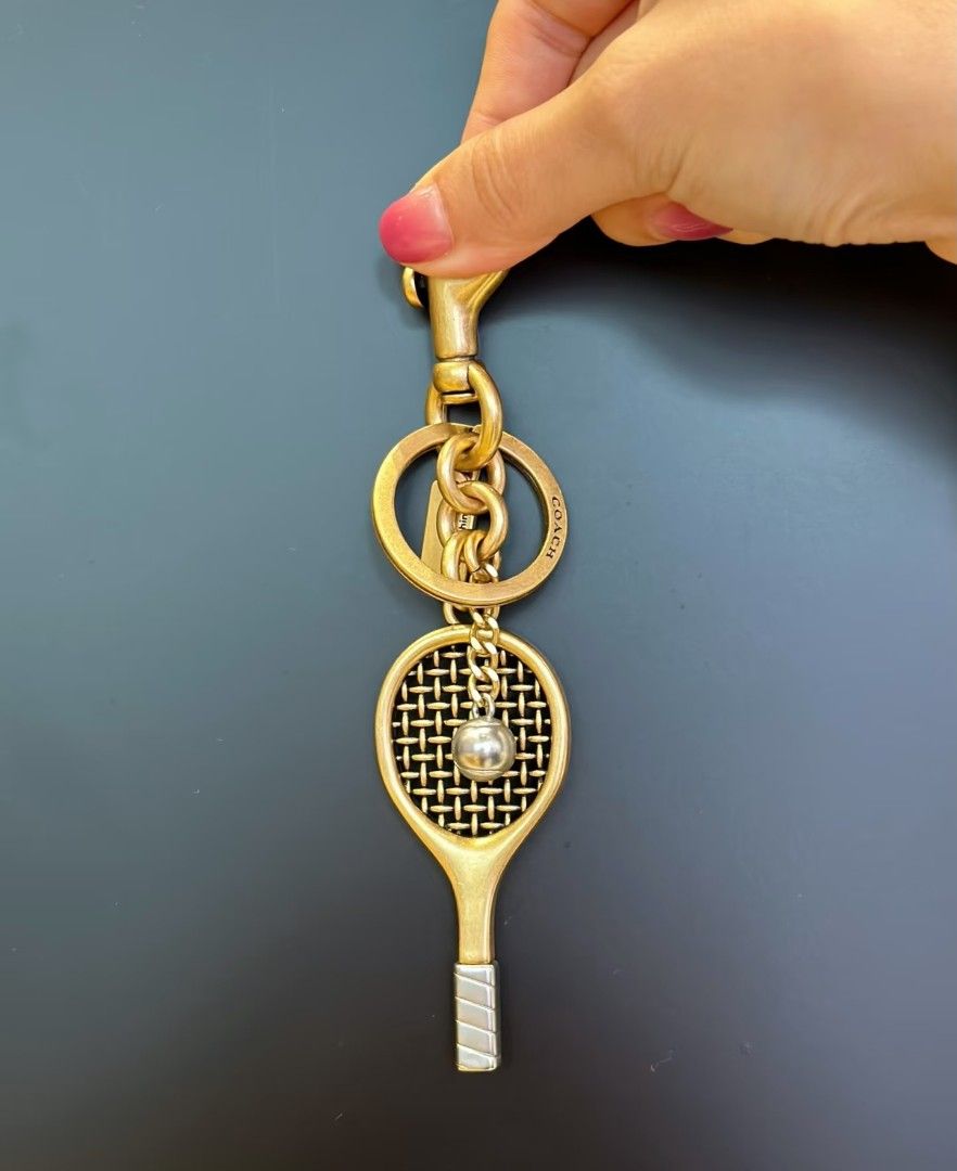 Coach Tennis Racket Bag Charm (Category: Charms) located in Pasig City. Submitted by maryjanegr (Listing ID 1463776902, Image 2). Description: 🍒 OG from Factory Outlet 🍒 Complete with Dustbag, Paperbag, and Care Card 🍒 Taguig Location.