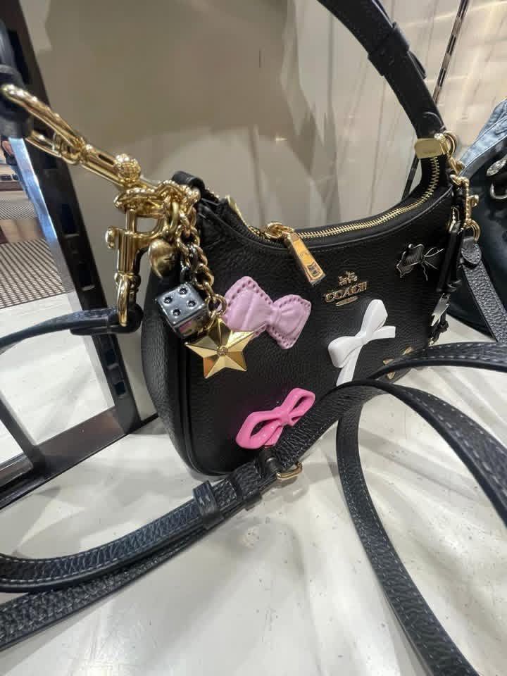 Coach Teri with Bow Charms (Category: Luxury Bags & Wallets) located in Abucay. Submitted by erindeclutterss (Listing ID 1463857504, Image 3). Description: - Authentic -Complete Inclusions - Includes a detachable crossbody strap for versatile wear - Elegant gold hardware details - Comes with a few adorable charms already attached.