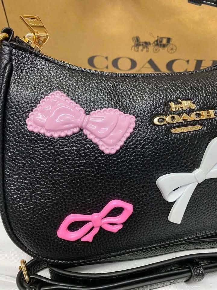 Coach Teri with Bow Charms (Category: Luxury Bags & Wallets) located in Abucay. Submitted by erindeclutterss (Listing ID 1463857504, Image 2). Description: - Authentic -Complete Inclusions - Includes a detachable crossbody strap for versatile wear - Elegant gold hardware details - Comes with a few adorable charms already attached.