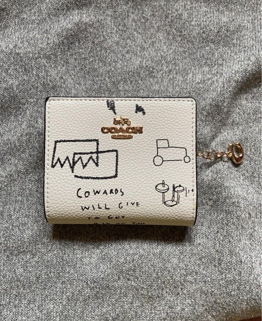 Coach x Basquiat Jean Michel Wallet (Category: Luxury Bags & Wallets) located in Makati City. Submitted by ellope (Listing ID 1460780327, Image 1). Description: Coach x Jean-Michel Basquiat bifold wallet in cream pebbled leather with iconic graphic print. Features card slots, ID window, and gold hardware. .