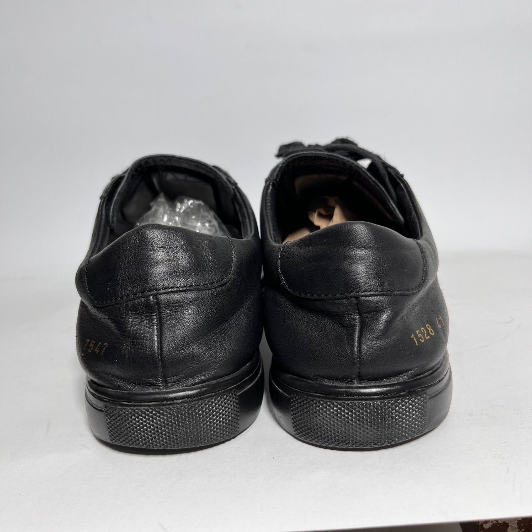 Common Projects Black Leather Sneakers (Category: Sneakers) located in Davao. Submitted by twistedswagger (Listing ID 1463864900, Image 3). Description: - Classic black leather sneakers - Brand: Common Projects - Signature gold serial number stamped on heel - Lace-up front - Made in Italy - Versatile for casual and smart-casual wear.
