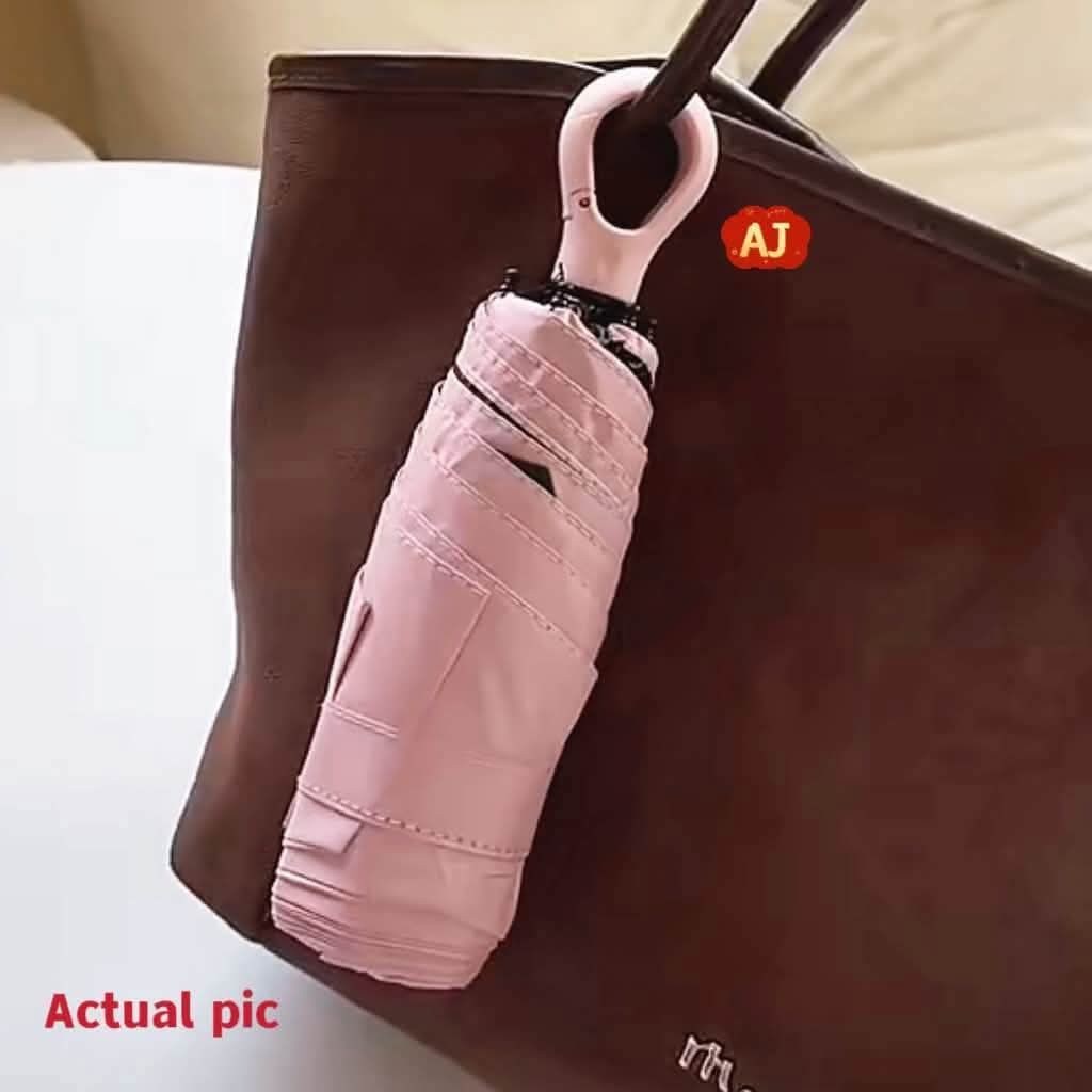 Compact Travel Umbrella - UPF 50+ Sun Protection (Category: Umbrellas) located in Manila. Submitted by iliasjen3082126 (Listing ID 1463929949, Image 2). Description: - Super compact, fits easily in your bag - Perfect for sunny days or unexpected rain - Offers UPF 50+ sun protection - Available in navy, black, and light pink - Features a convenient loop for hanging.