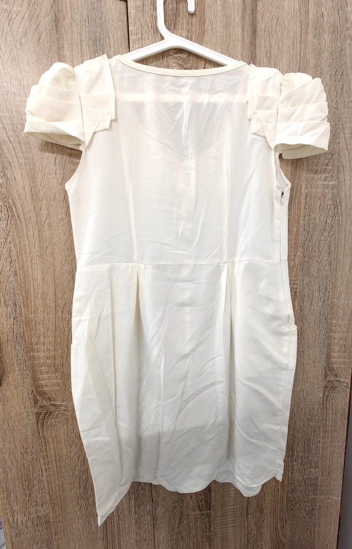 Cream Puff Sleeve Button Front Dress with Pockets (Category: Dresses) located in Las Pinas. Submitted by offtonewhome (Listing ID 1463793078, Image 2). Description: - Chic cream-colored dress - Short puff sleeves with charming ruffled detail - Convenient button-front closure - Functional side pockets - Flattering knee-length cut - Versatile for casual or semi-formal events - Effortless to style for any occasion.