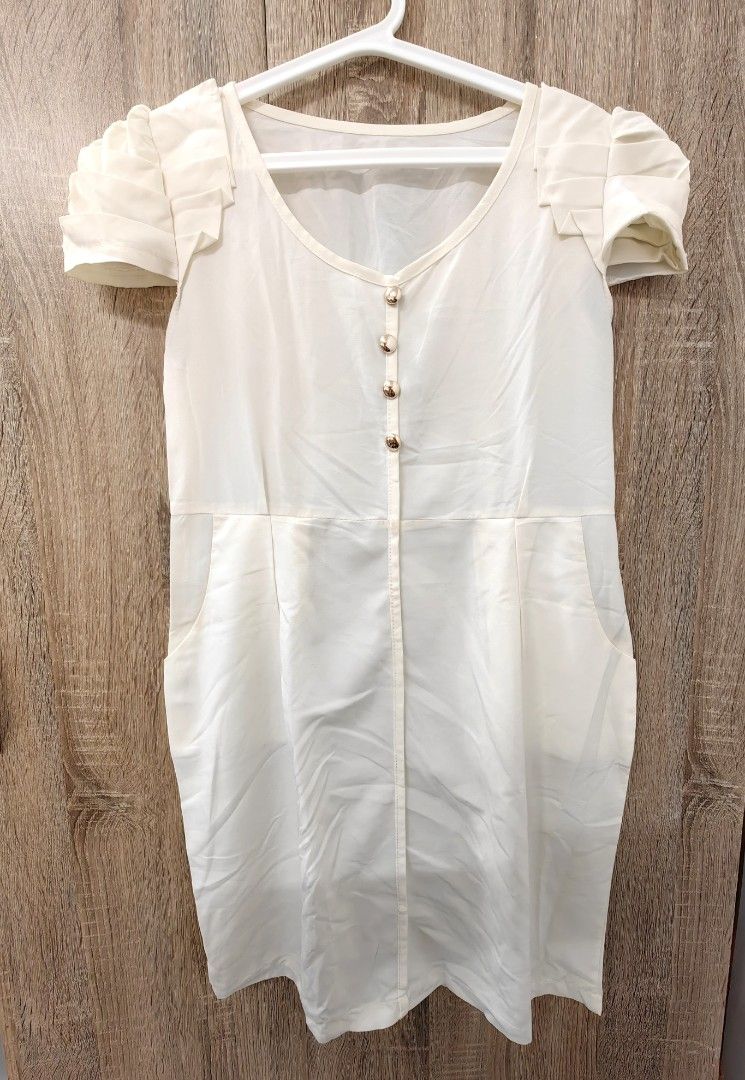 Cream Puff Sleeve Button Front Dress with Pockets (Category: Dresses) located in Las Pinas. Submitted by offtonewhome (Listing ID 1463793078, Image 1). Description: - Chic cream-colored dress - Short puff sleeves with charming ruffled detail - Convenient button-front closure - Functional side pockets - Flattering knee-length cut - Versatile for casual or semi-formal events - Effortless to style for any occasion.