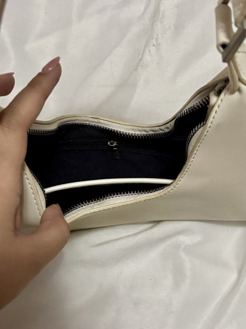 Cream Shoulder Bag (Category: Shoulder Bags) located in Taguig. Submitted by thenemy (Listing ID 1463901597, Image 2). Description: - Cream colored shoulder bag - Structured hard material - Issue: Strap is deformed at the top but unnoticeable when worn on the shoulder. There are a few dust marka that can be cleaned or washed/wiped off. - Honest review: The bag itself looks really nice when worn, but it only fits a few essentials like your phone, 