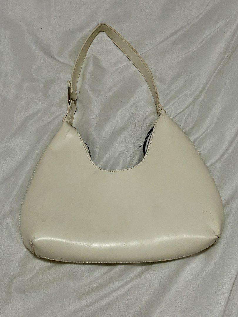 Cream Shoulder Bag (Category: Shoulder Bags) located in Taguig. Submitted by thenemy (Listing ID 1463901597, Image 1). Description: - Cream colored shoulder bag - Structured hard material - Issue: Strap is deformed at the top but unnoticeable when worn on the shoulder. There are a few dust marka that can be cleaned or washed/wiped off. - Honest review: The bag itself looks really nice when worn, but it only fits a few essentials like your phone, 