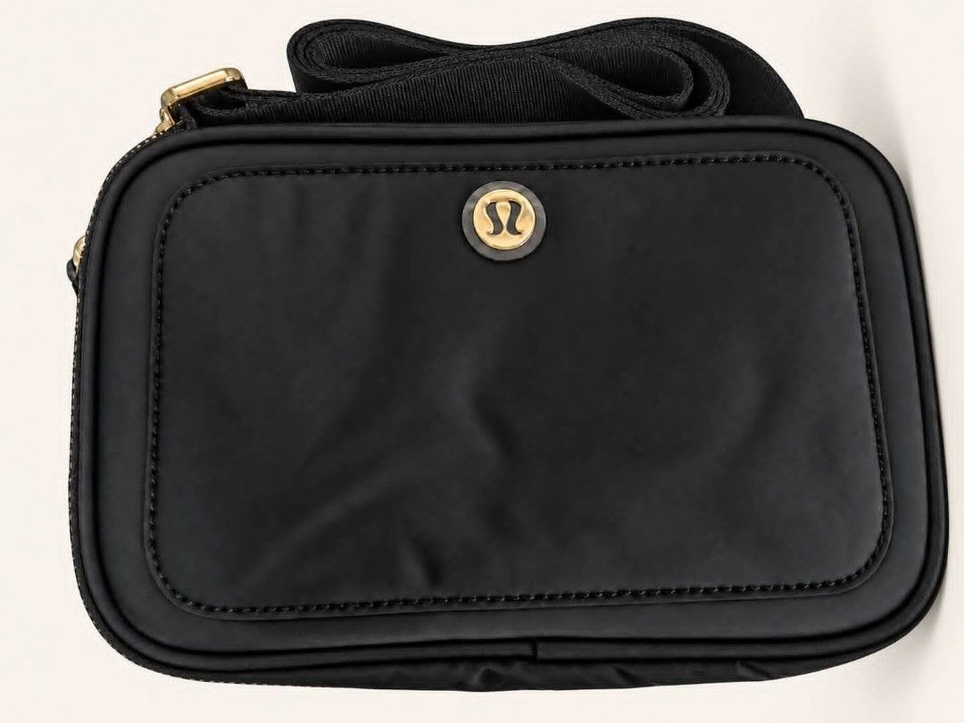 Crossbody Camera Bag 2L (Category: Cross-body Bags) located in Las Pinas. Submitted by Paninda.ph (Listing ID 1463937180, Image 1). Description: - Lululemon Everywhere Belt Bag in Black - Classic gold logo hardware - Adjustable strap for crossbody or belt wear - Ideal for on-the-go essentials - Made from durable nylon material - Secure zip closure.