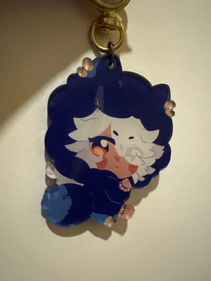 Cyno - Genshin Impact Acrylic Keychain (Category: Character Goods) located in Manila. Submitted by tsukkisell (Listing ID 1463925310, Image 1). Description: Chibi Genshin Impact Cyno acrylic keychain with gold cat clasp! From the Austerity Cyno fanzine project on twt. Bundle was originally at $80+. Plastic film still intact. Please help him find a new home!! 🫶.
