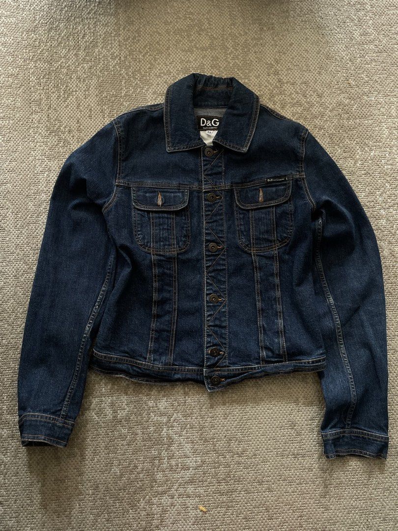 D&G Dolce & Gabbana Denim Jacket XS (Category: Coats, Jackets and Outerwear) located in Manila. Submitted by rei.ocn (Listing ID 1463846066, Image 1). Description: - Classic dark wash denim jacket from D&G - Features button closure - Two chest pockets with D&G logo detail - Versatile staple piece - Size XS.