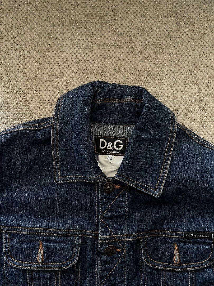 D&G Dolce & Gabbana Denim Jacket XS (Category: Coats, Jackets and Outerwear) located in Manila. Submitted by rei.ocn (Listing ID 1463846066, Image 3). Description: - Classic dark wash denim jacket from D&G - Features button closure - Two chest pockets with D&G logo detail - Versatile staple piece - Size XS.