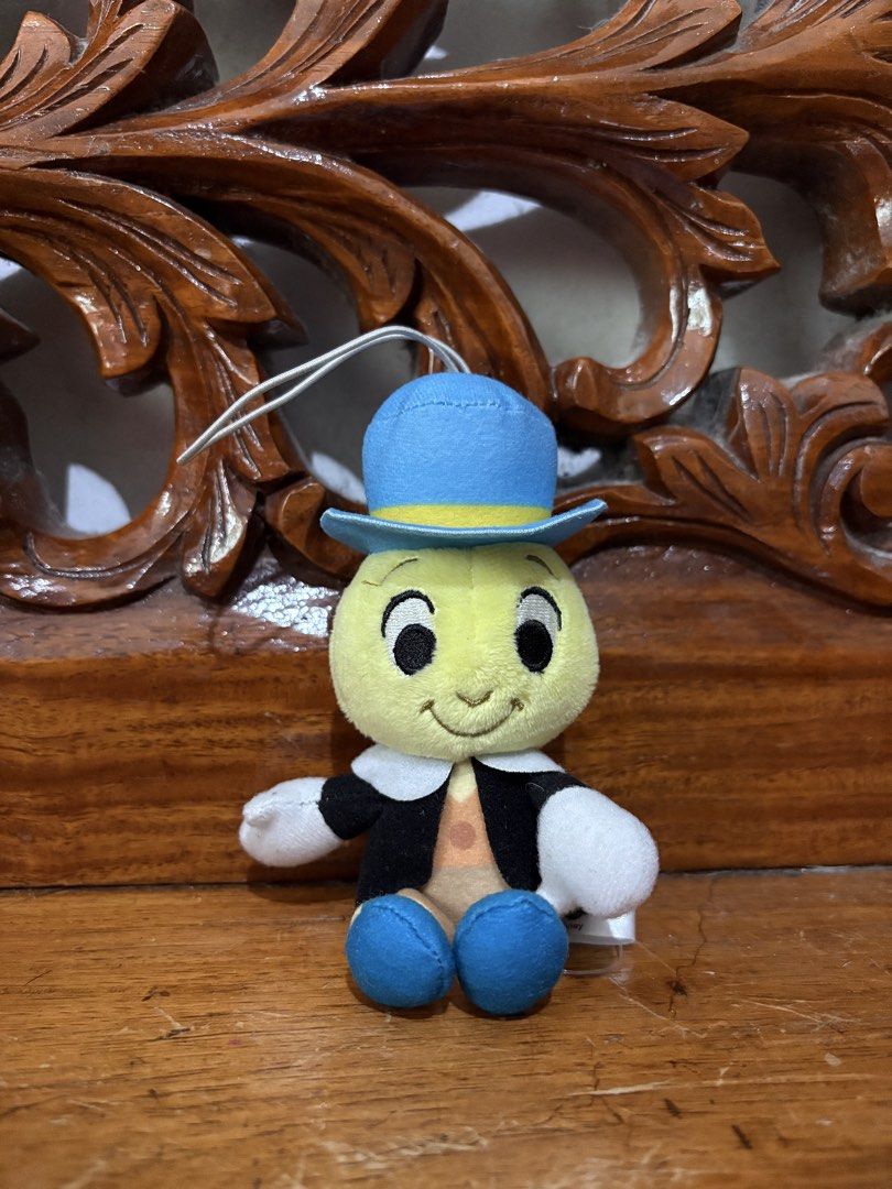 Disney 100 Jiminy Cricket Plush Toy (Category: Plushies & Soft Toys) located in Quezon City. Submitted by rxyel (Listing ID 1463805099, Image 1). Description: - Cute Jiminy Cricket plush toy - Part of the exclusive Disney 100 collection - Features his classic outfit: blue hat and jacket - Includes a convenient loop for hanging - Ideal for Disney enthusiasts and collectors - Small and portable size.