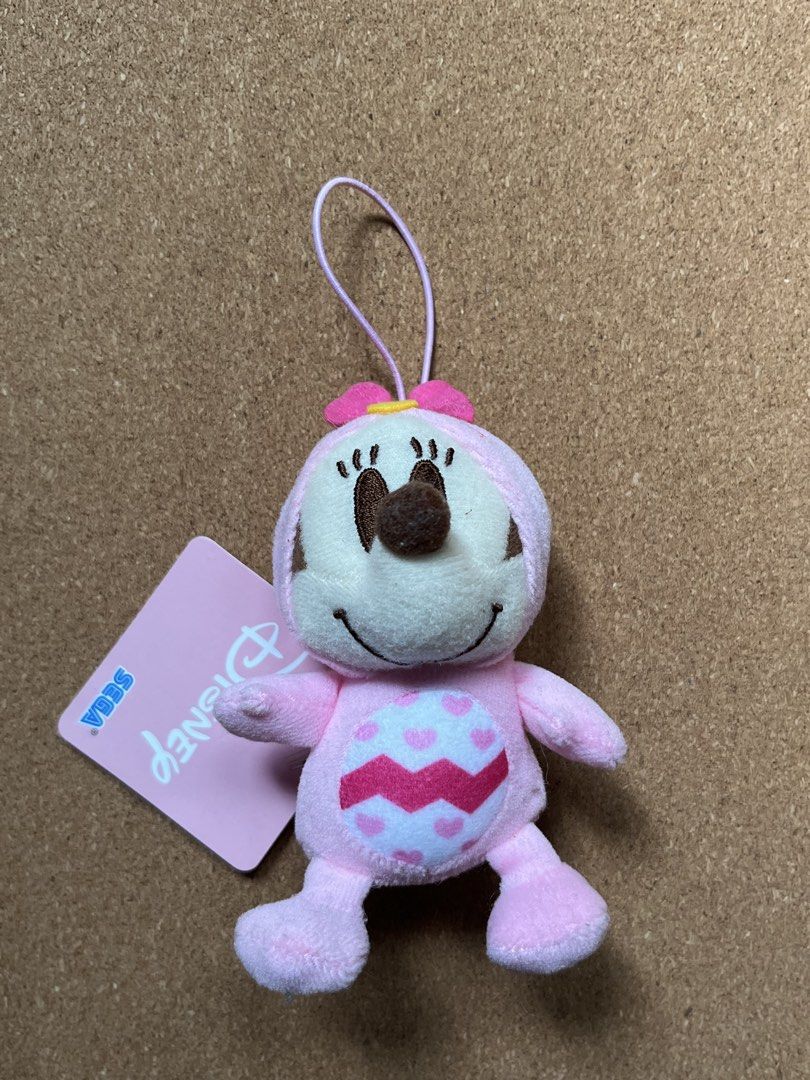 Disney SEGA Pink Easter Egg Minnie Mouse Plush Toy (Category: Plushies & Soft Toys) located in Baguio. Submitted by gaara1234 (Listing ID 1463749017, Image 1). Description: - Adorable pink Minnie Mouse plush toy. - Features a unique Easter egg design on its belly with hearts and zigzags. - Adorned with a sweet pink bow on its head. - Includes a convenient loop for hanging. - Comes with original Disney and SEGA tags, ensuring authenticity. - Ideal