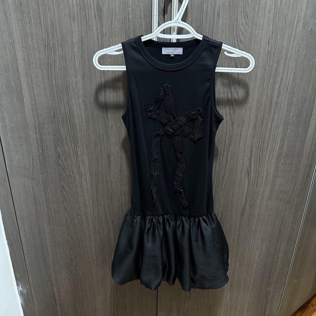 District One Black Coquette Bow Dress (Category: Dresses) located in Pasig City. Submitted by prettygirlmantra (Listing ID 1463872177, Image 3). Description: - Worn once. Bought from District One Vietnam - Elegant black sleeveless dress - Features a delicate lace bow detail on the front - Stylish bubble hem skirt - Estimated size: Medium (M) - Ideal for evening events, parties, or a night out - Comfortable and fashionable design.