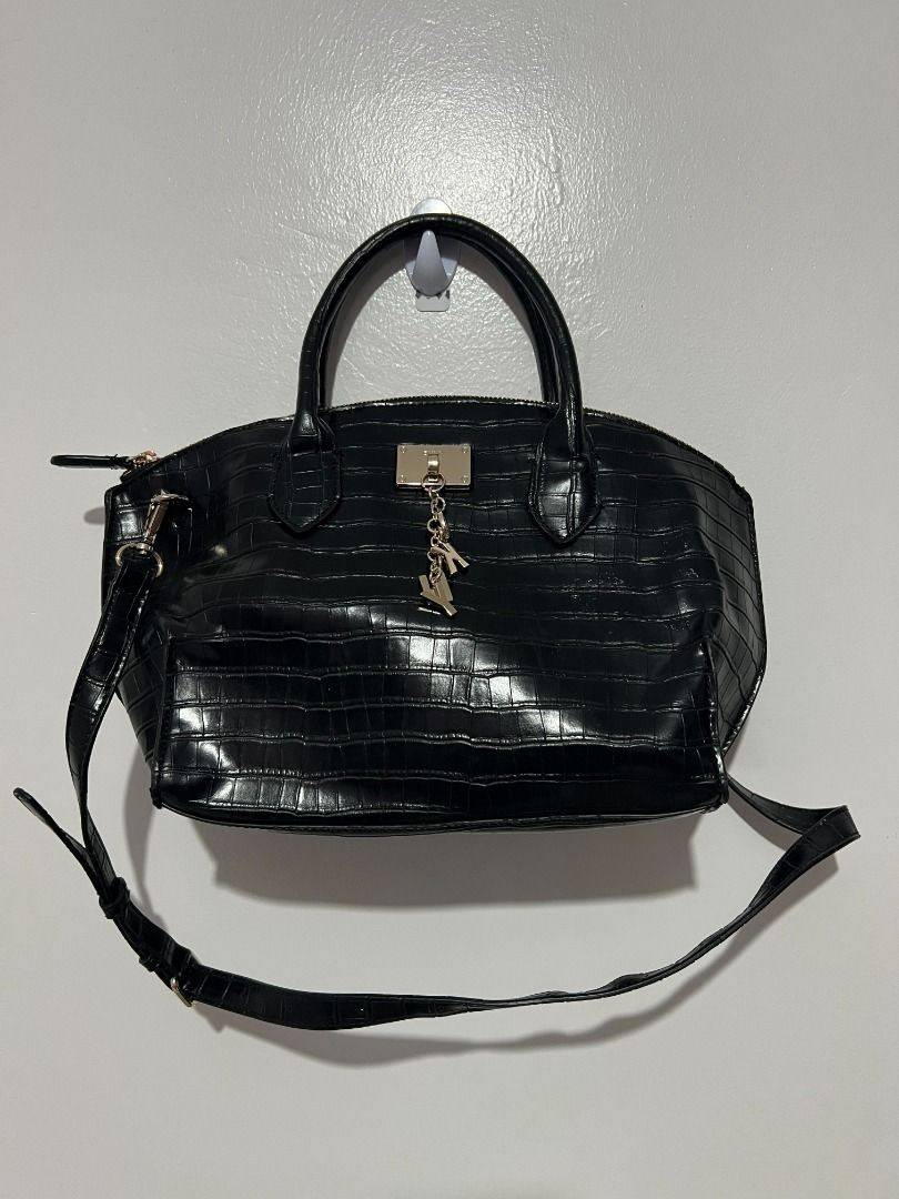 DKNY Elissa Croc-Embossed Leather Satchel (Black) (Category: Shoulder Bags) located in Davao. Submitted by jpnusapasabuyfindsdvo (Listing ID 1463896227, Image 2). Description: - NEVER USED BAG WITH A TAG, BOUGHT FROM USA - Stylish black satchel handbag - Features a sophisticated croc-embossed texture - Comes with a comfortable top handle - Includes a detachable shoulder strap for versatile wear - Secure zipper closure - Adorned with a cute, eye-c